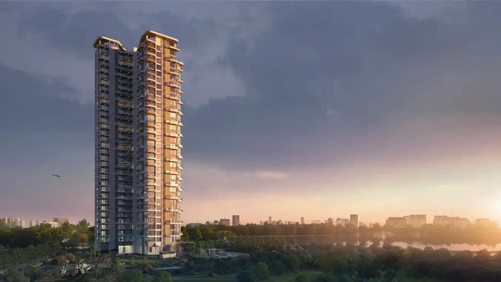 The Solitaire tower rising above the trees at sunrise, the sky pink and gold over the city