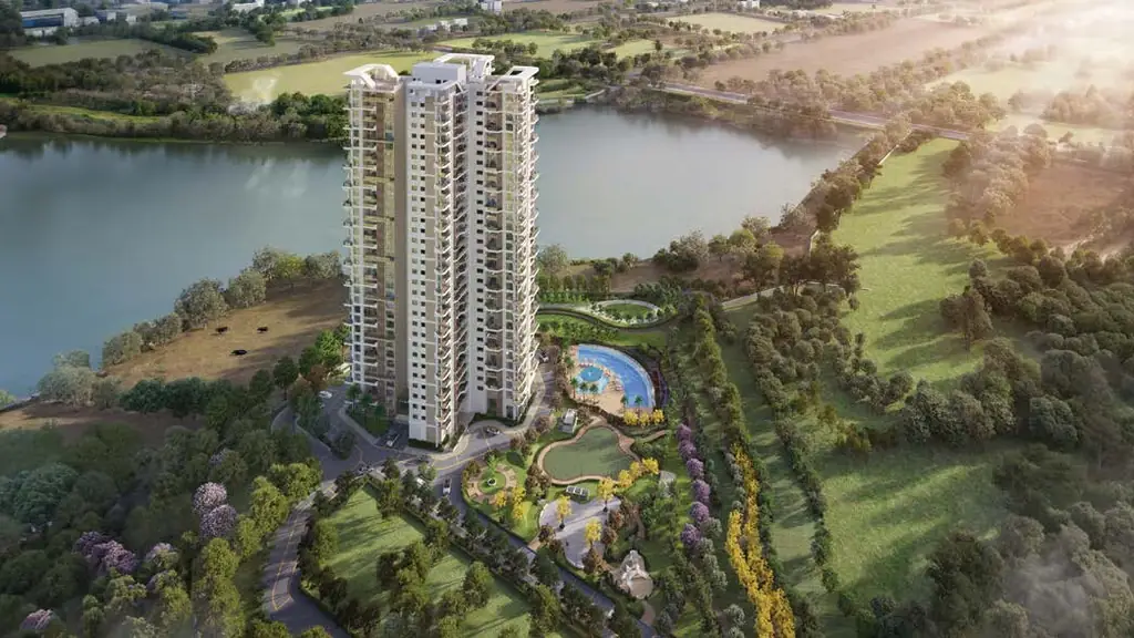 Aerial view of The Solitaire tower and its pool garden beside the lake, fields and trees beyond