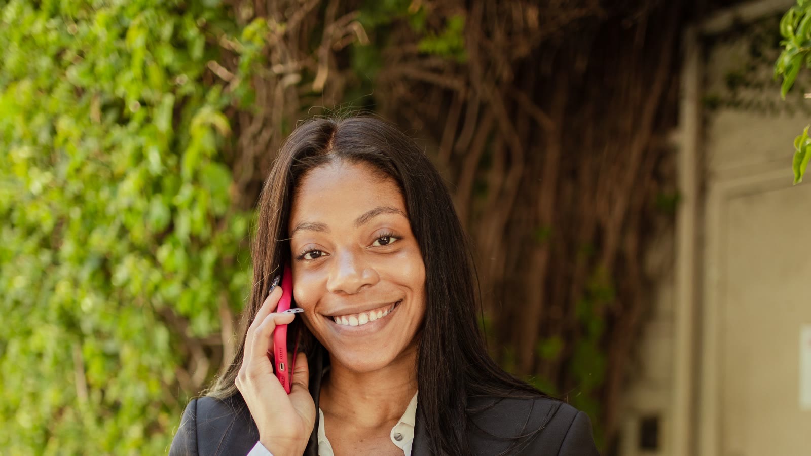 A relationship manager taking a call outside the office, smiling
